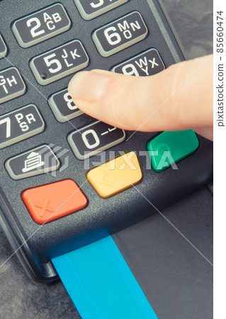 Hand of woman entering PIN code on payment terminal. Cashless paying for shopping. Finance concept Hand of woman entering PIN code on payment terminal. Cashless paying for shopping. Finance concept 85660474