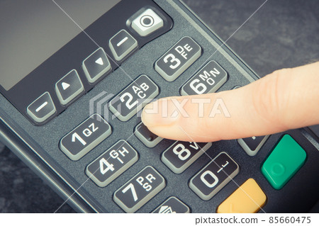 Hand of woman using credit card reader to enter PIN code. Cashless paying. Finance and banking Hand of woman using credit card reader to enter PIN code. Cashless paying. Finance and banking 85660475