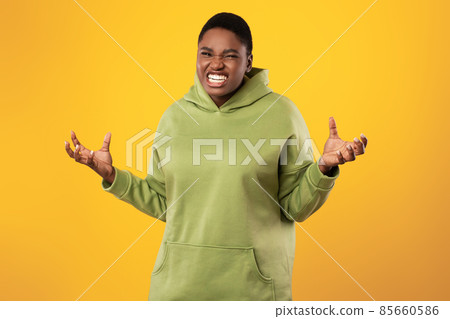 Angry Overweight Black Woman Clenching Teeth Posing Over Yellow Background Angry Overweight Black Woman Clenching Teeth Posing Over Yellow Background 85660586