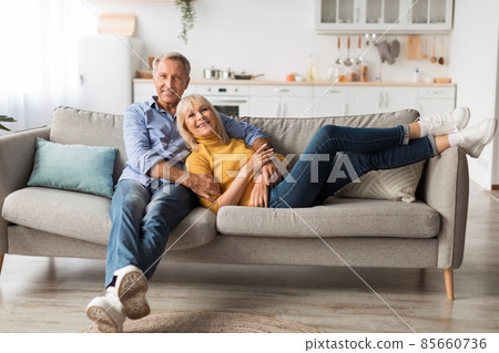 Mature Spouses Hugging Sitting On Sofa Together At Home Mature Spouses Hugging Sitting On Sofa Together At Home 85660736