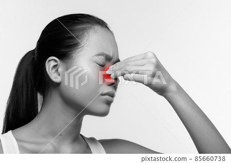 Unhappy japanese woman rubbing red sore nose Unhappy japanese woman rubbing red sore nose 85660738
