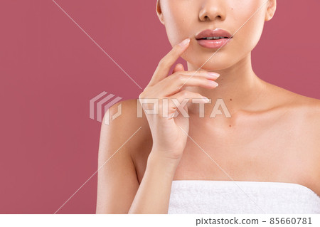 Cropped of sensual lady wrapped in towel touching her lips 85660781