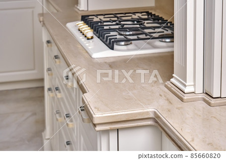 Gas stove cooktop on acrylic solid surface countertop in kitchen Gas stove cooktop on acrylic solid surface countertop in kitchen 85660820