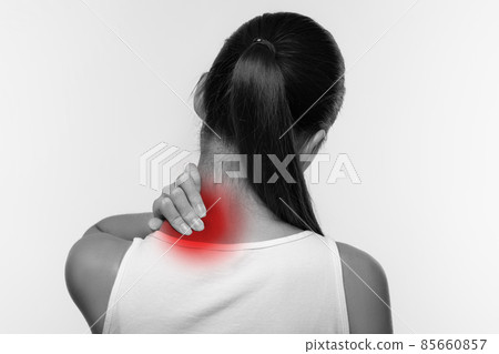 Unrecognizable woman suffering from pain, massaging neck Unrecognizable woman suffering from pain, massaging neck 85660857