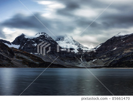 Mount Assiniboine with cloudy flowing in Lake Magog on gloomy at provincial park Mount Assiniboine with cloudy flowing in Lake Magog on gloomy at provincial park 85661470