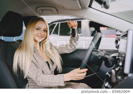 Stylish and elegant woman in a car salon Stylish and elegant woman in a car salon 85662004