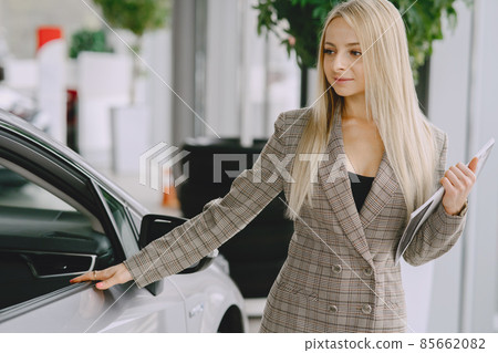 Stylish and elegant woman in a car salon Stylish and elegant woman in a car salon 85662082