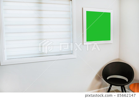 A reading chair armchair with a lamp, blanket and a open book. Empty white wall with mockup picture in simple living room interior. Copy space A reading chair armchair with a lamp, blanket and a open book. Empty white wall with mockup picture in simple living room interior. Copy space 85662147