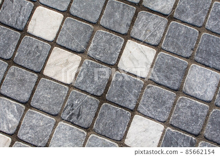 Weathered Wall Background. Old dirty wall covered with thin ceramic square tiles. White gray light blue color. Vintage style. Clay ceramic tiles. Old house outside. Worn and dusty surface of building Weathered Wall Background. Old dirty wall covered with thin ceramic square tiles. White gray light blue color. Vintage style. Clay ceramic tiles. Old house outside. Worn and dusty surface of building 85662154