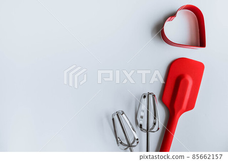 Baking supplies on white. Spatula, mixer whisks, cookie cutter on white background Baking supplies on white. Spatula, mixer whisks, cookie cutter on white background 85662157