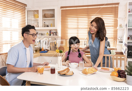 Asian family enjoy eating breakfast together in kitchen room at home. 85662223