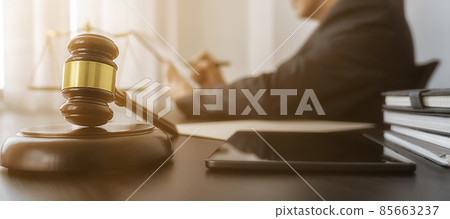 Professional lawyer considering with contract papers in courtroom. Justice, Law, Attorney and Court judge concept. Professional lawyer considering with contract papers in courtroom. Justice, Law, Attorney and Court judge concept. 85663237