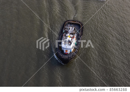 Aerial View of Tugboat in Fraser River and Mountain Landscape in background 85663288