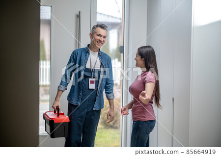 Woman inviting man to the house with tools Woman inviting man to the house with tools 85664919