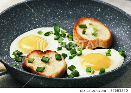 breakfast with fried eggs and green onions and baguette breakfast with fried eggs and green onions and baguette 85665250