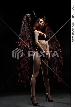 Sexy woman in provocative fallen angel costume Sexy woman in provocative fallen angel costume 85665533