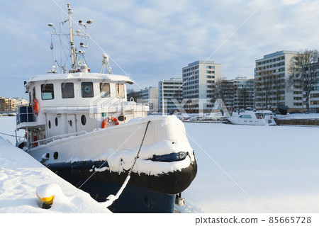 Small white boat is moored at river coast Small white boat is moored at river coast 85665728