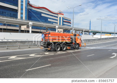 cleaning machine pours water on the road in Moscow 85665757