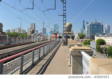 Lastochka train travels along the Luzhnetsky Metro bridge in Moscow 85665931