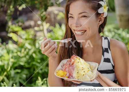 Shaved ice hawaiian local frozen food treat Asian happy woman eating snow cone at Hawaii vacation summer holiday 85665971