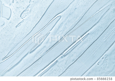 Liquid blue gel cosmetic smudge background. Water texture banner. Wallpaper for Korean cosmetics. Cream gel blue transparent cosmetic serum sample texture with bubbles on white background. Sanitizer Liquid blue gel cosmetic smudge background. Water texture banner. Wallpaper for Korean cosmetics. Cream gel blue transparent cosmetic serum sample texture with bubbles on white background. Sanitizer 85666158