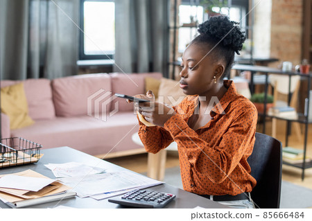 Young African female auditor taking photo of financial papers 85666484