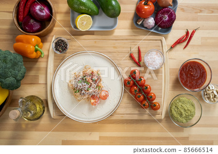 Flatlay of italian pasta in plate surrounded by fresh fruits and vegetables Flatlay of italian pasta in plate surrounded by fresh fruits and vegetables 85666514