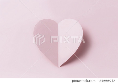 Love message or Saint Valentine Day conceptual flat lay. Top view on cut and curved paper pink heart with shadow on pink background. Minimalistic mockup for valentine card, invitation or greeting card 85666912