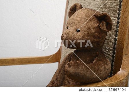 shabby teddy bear sitting in an vintage armchair shabby teddy bear sitting in an vintage armchair 85667404