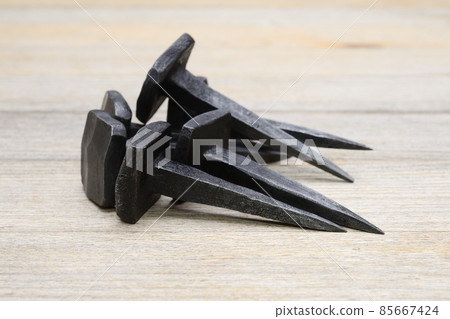 forged nails on a wooden background 85667424