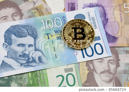 Bitcoin on top of a stack of Serbian dinar 85668724