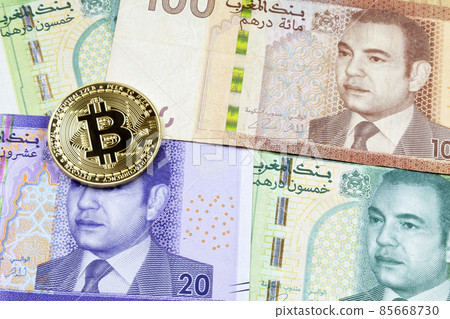 Bitcoin on top of a stack of Moroccan dirham Bitcoin on top of a stack of Moroccan dirham 85668730
