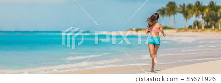 Athlete runner fitness woman running on Caribbean beach landscape banner panoramic background. Active exercise fit girl training cardio in summer lifestyle 85671926