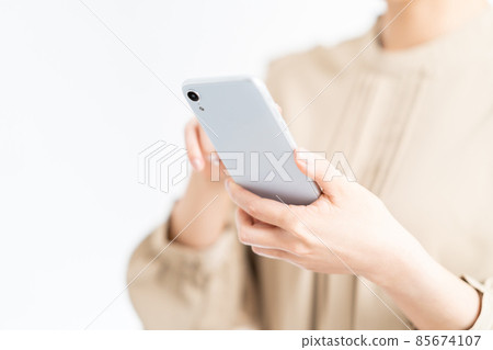 Female (parts) operating a smartphone 85674107