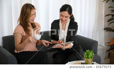 Female life insurance agent or realtor having a meeting with her client Female life insurance agent or realtor having a meeting with her client 85675073