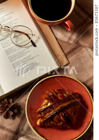 book, glasses, cinnamon bun and cup of coffee 85675387