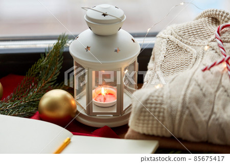 candle burning in christmas lantern and sweater candle burning in christmas lantern and sweater 85675417