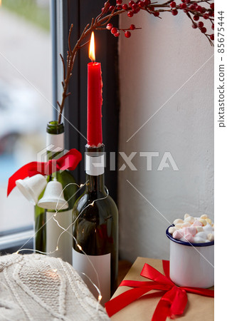 red christmas candle burning in wine bottle red christmas candle burning in wine bottle 85675444