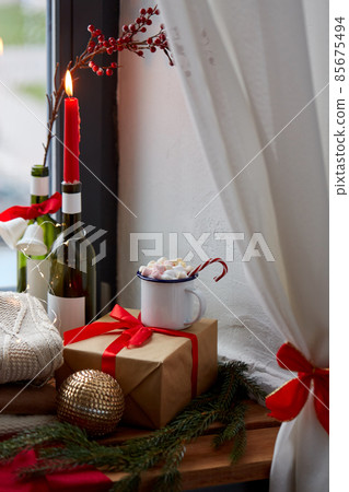 cup of drink , christmas gift and candle on sill 85675494