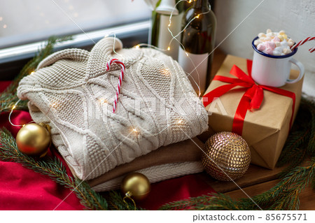 close up of sweater and christmas decor on sill 85675571