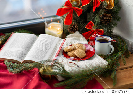 book, cookies, glasses, coffee and christmas decor 85675574