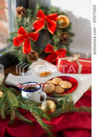 cup of coffee, cookies and christmas decor at home cup of coffee, cookies and christmas decor at home 85675602