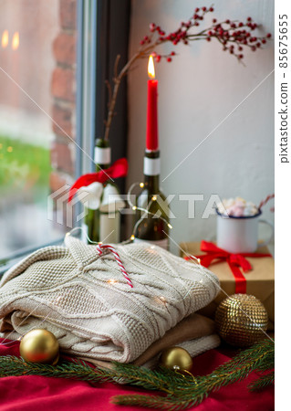 close up of sweater and christmas decor on sill close up of sweater and christmas decor on sill 85675655