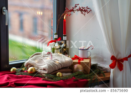 close up of sweater and christmas decor on sill 85675690