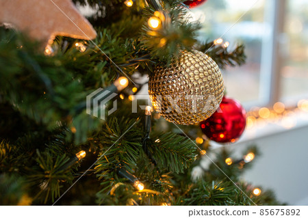 close up of golden ball on christmas tree 85675892