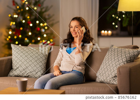 happy woman calling on phone at home on christmas 85676162