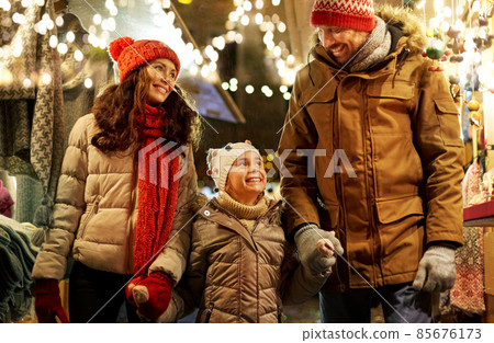happy family at christmas market in city 85676173