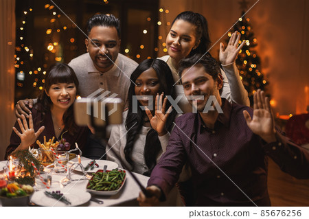 friends taking selfie on christmas dinner at home 85676256