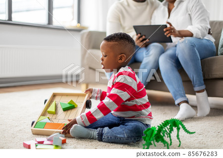 african american boy playing with toys at home african american boy playing with toys at home 85676283