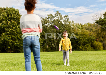 happy children playing with flying disc at park 85676333